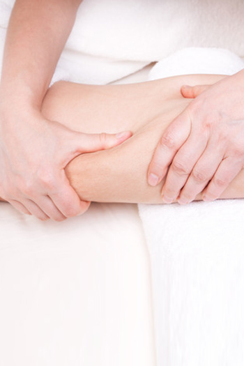 Therapist doing a deep tissue massage to improve skin condition